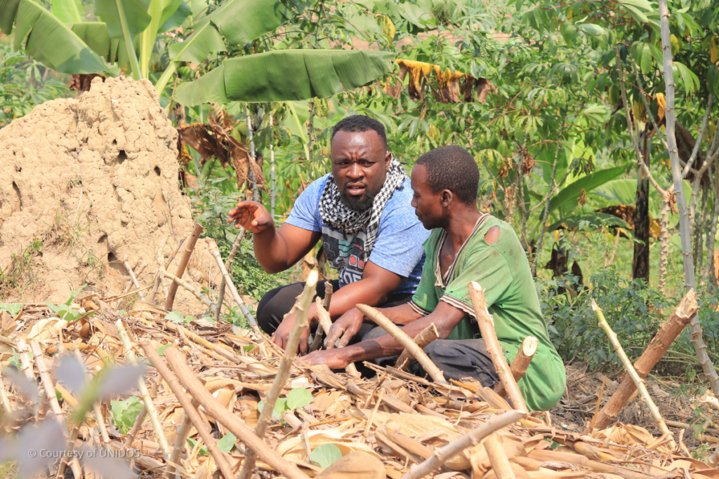 Paulinho Muzaliwa with a farmer at the Nakivale settlement.